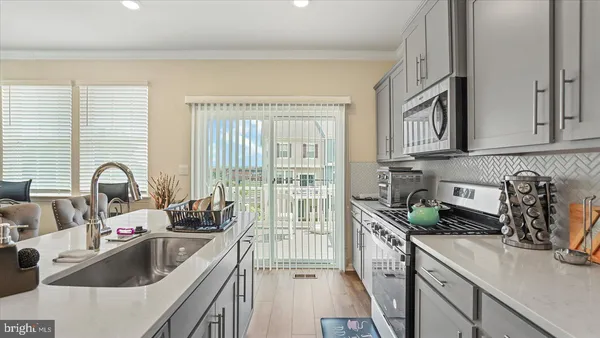 a kitchen that has a sink and a stove