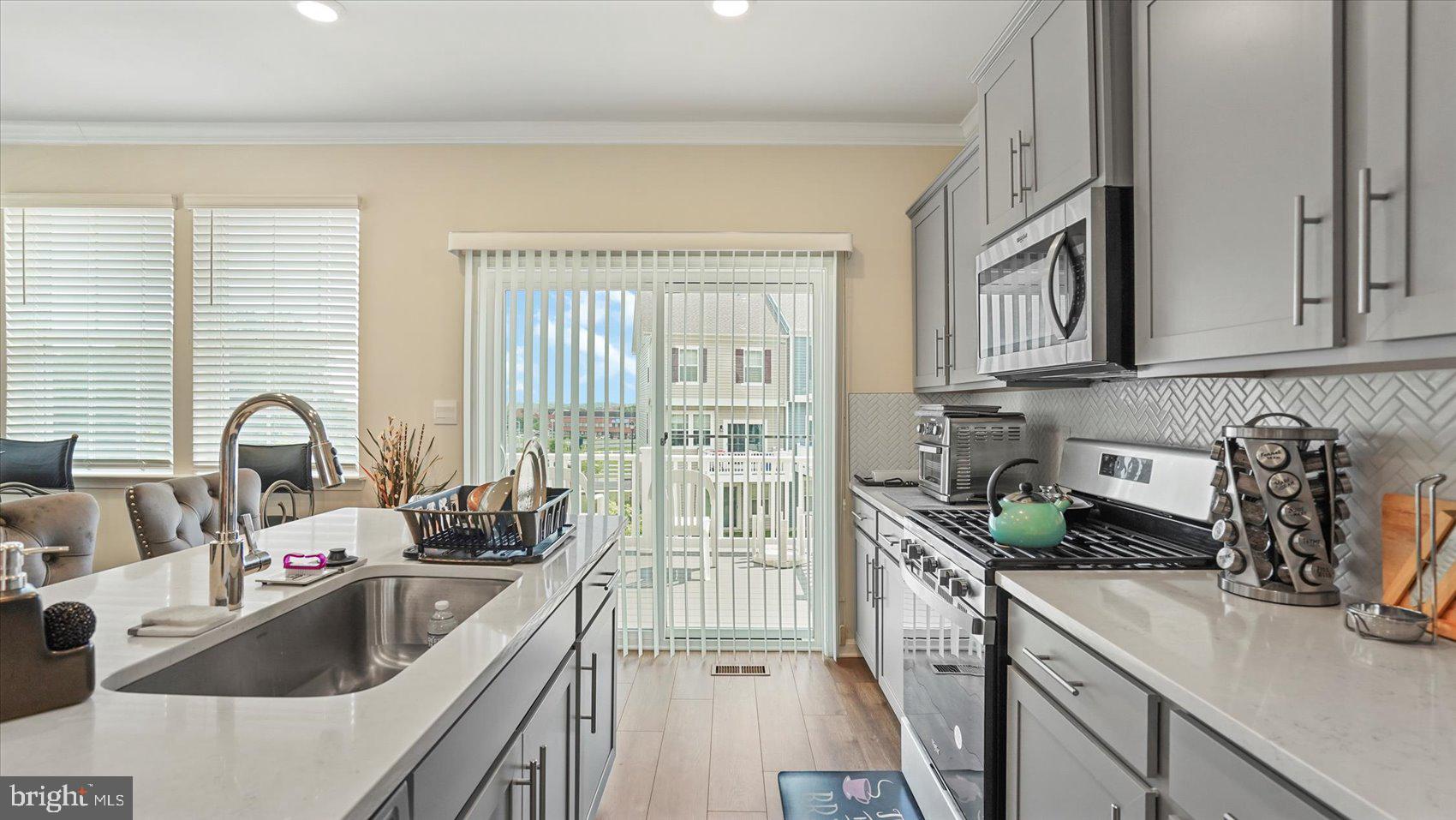 5085 Silver Oak Drive Rosedale, MD 21237 - Photo 13 of 48 a kitchen that has a sink and a stove