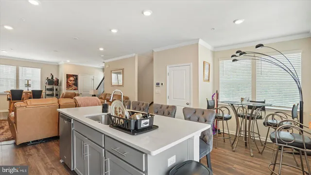 a kitchen with a table chairs and wooden floor