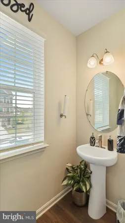 a bathroom with a sink a mirror and a window