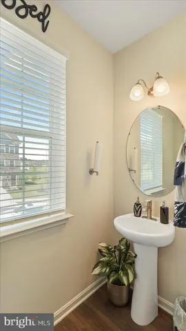 a bathroom with a sink a mirror and a window