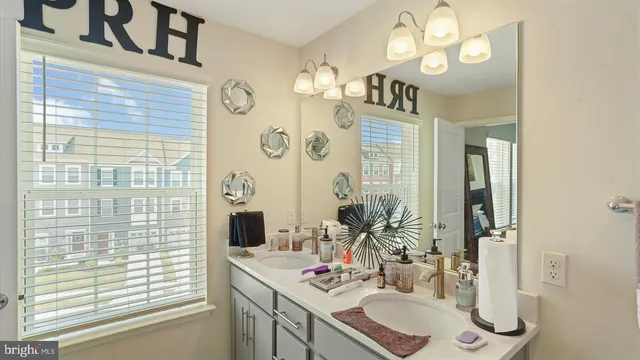 a bathroom with a sink vanity granite and a mirror