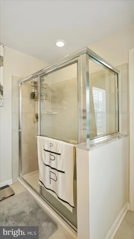 a bathroom with a shower and a mirror