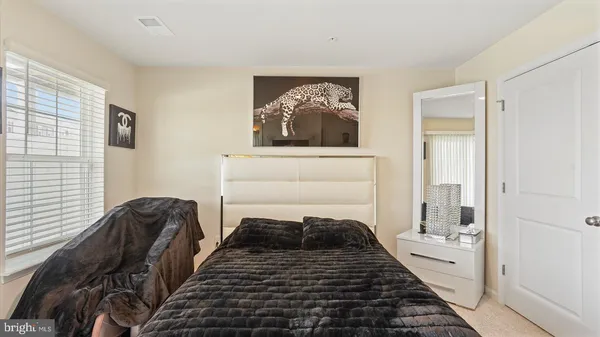 a bed sitting in a bedroom next to a window