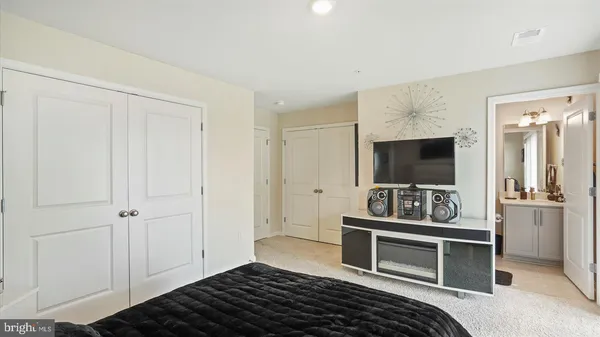 a bedroom with furniture and flat screen tv