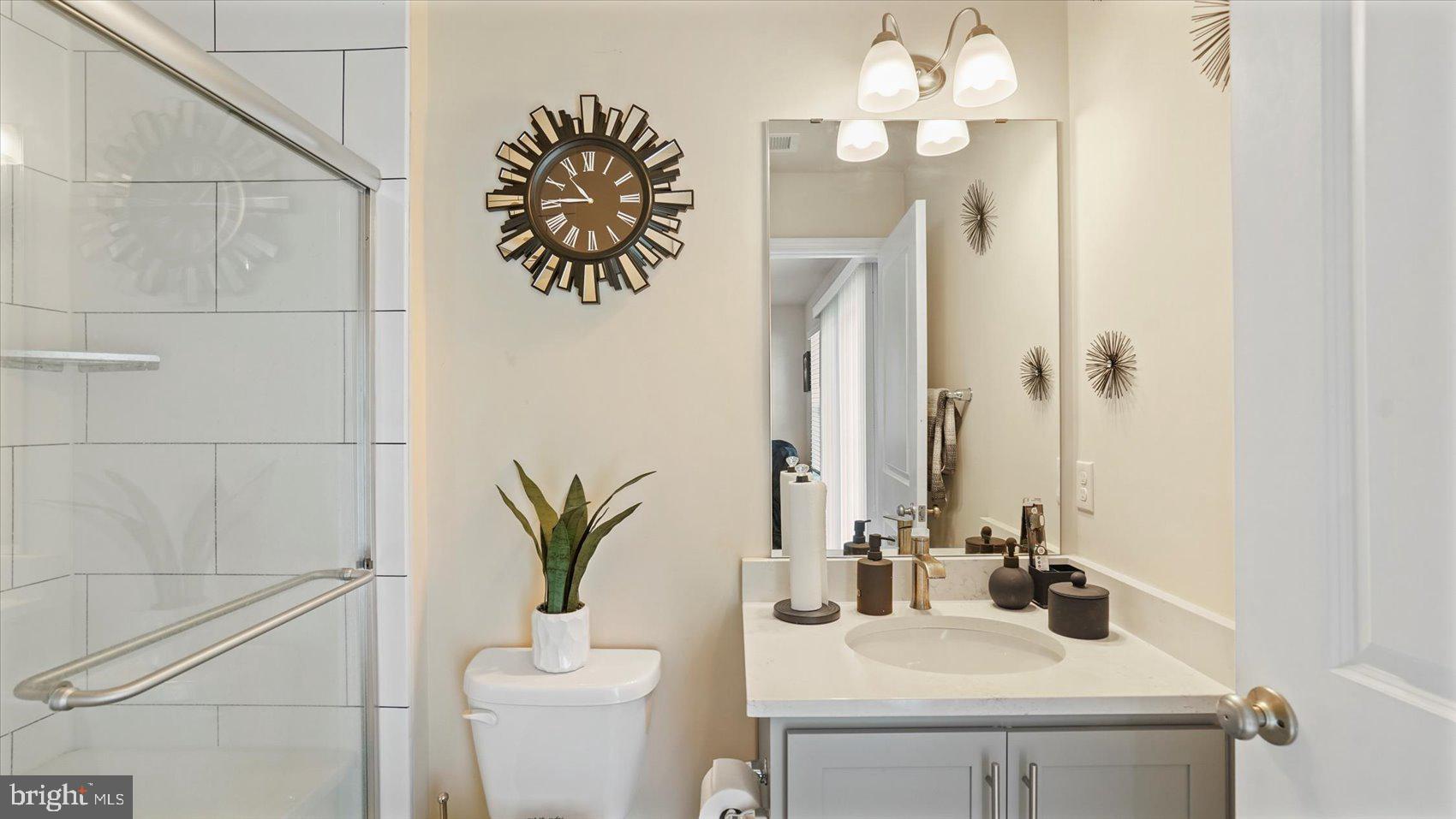 5085 Silver Oak Drive Rosedale, MD 21237 - Photo 8 of 48 a bathroom with a sink a mirror and a toilet