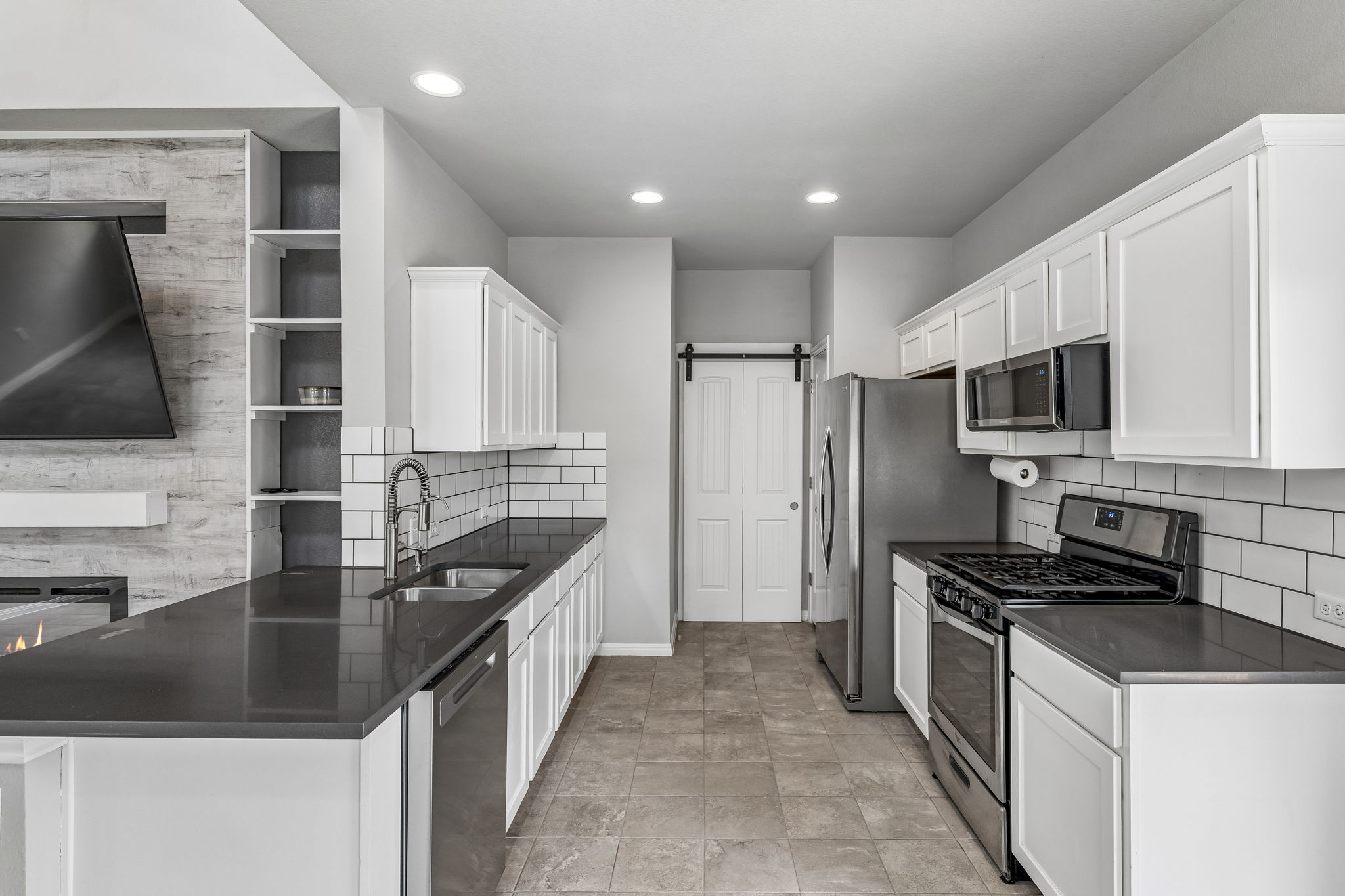 689 Nautical Loop Kyle, TX 78640 - Photo 3 of 34 A sleek kitchen features modern stainless steel appliances and crisp white cabinetry.