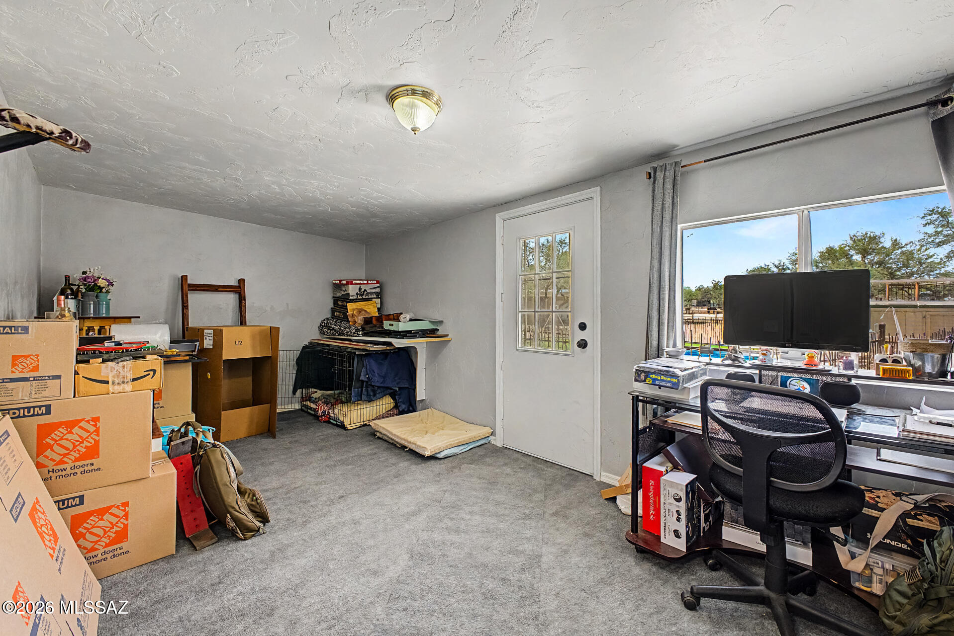 4231 East Pinal Street Tucson, AZ 85739 - Photo 18 of 36 a view of a workspace with furniture and a window