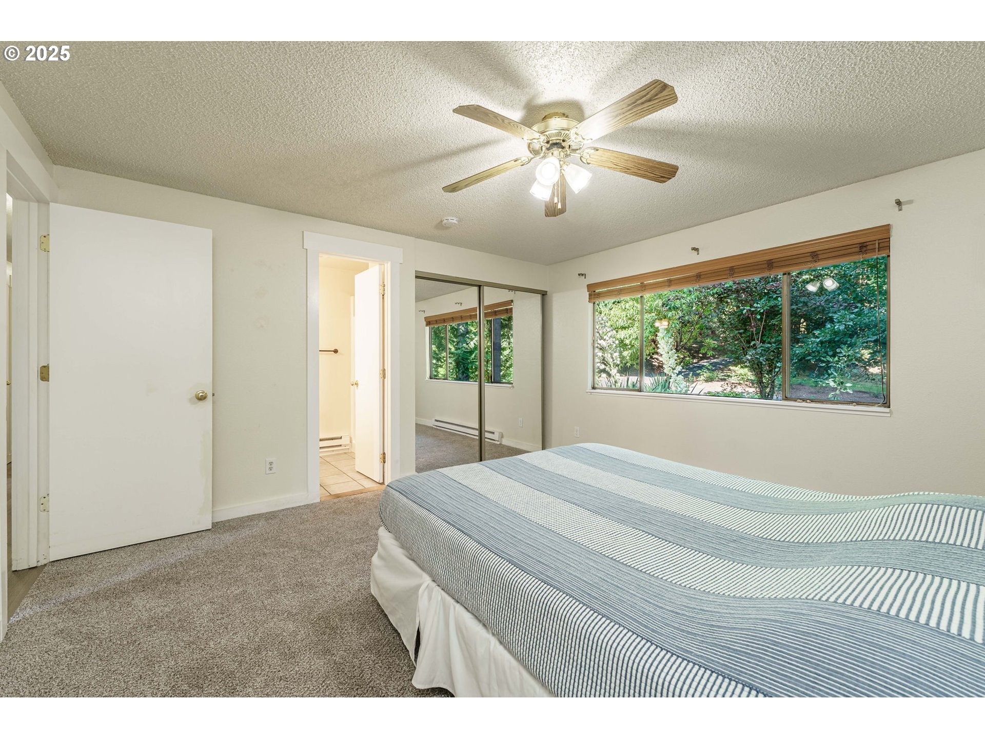 71682 Neer City Road Rainier, OR 97048 - Photo 16 of 48 a bedroom with a large bed and a chandelier