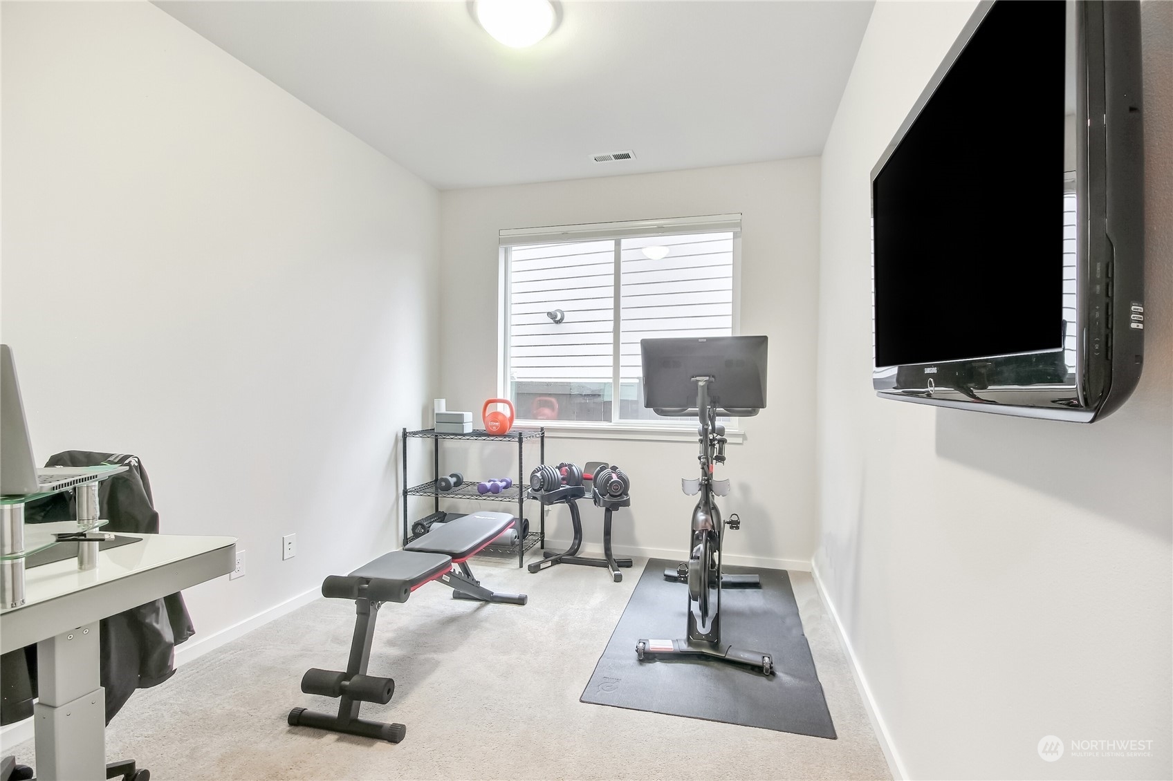 3822 Northeast 24th Court Renton, WA 98056 - Photo 27 of 37 a view of a livingroom with workspace and a flat screen tv