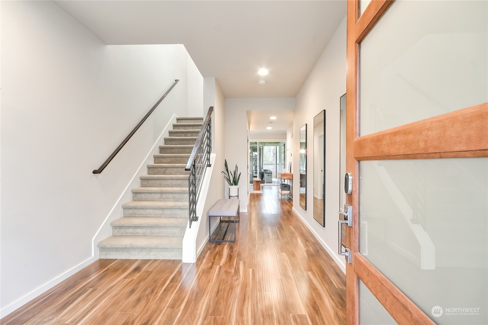 3822 Northeast 24th Court Renton, WA 98056 - Photo 3 of 37 a view of a hallway with wooden floor and staircase