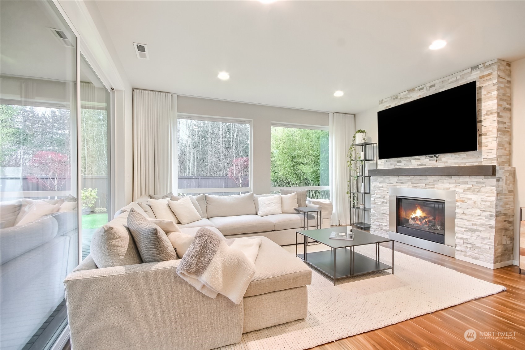 3822 Northeast 24th Court Renton, WA 98056 - Photo 5 of 37 a living room with furniture a fireplace and a flat screen tv
