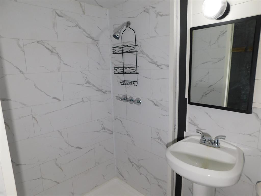 300 South Main Street Springhill, LA 71075 - Photo 31 of 35 a bathroom with a sink and a mirror