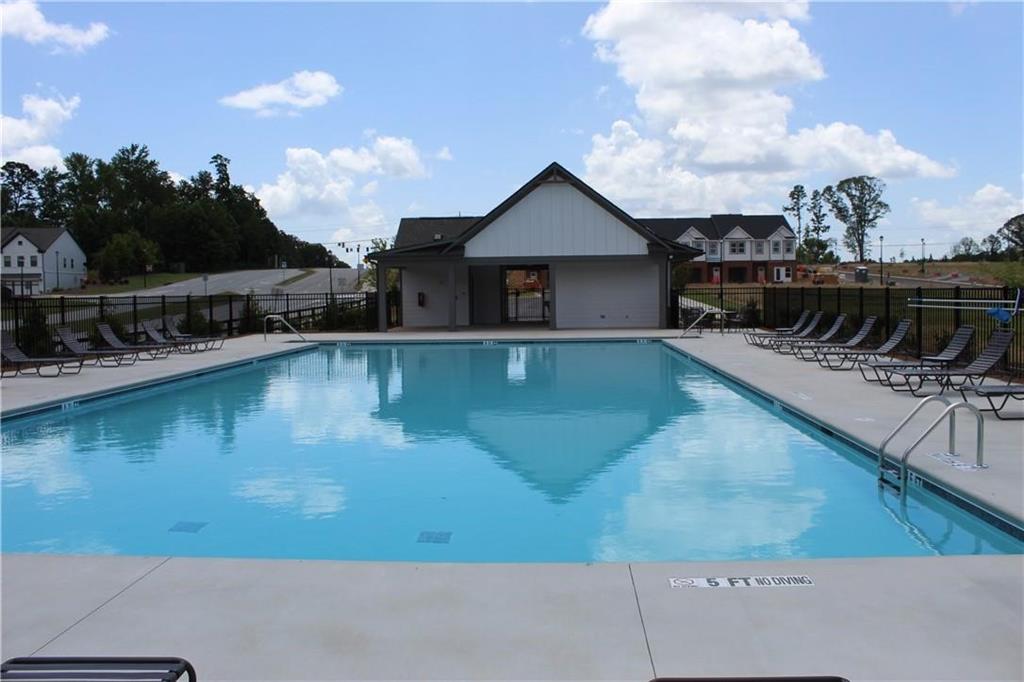 5299 Magnolia Grove Way, Unit 182 Gainesville, GA 30504 - Photo 21 of 79 a view of a house with pool and lake view