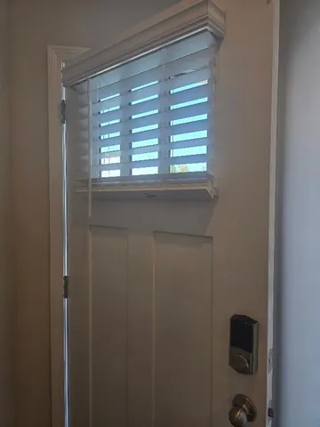 a view of a dining room with furniture and a potted plant