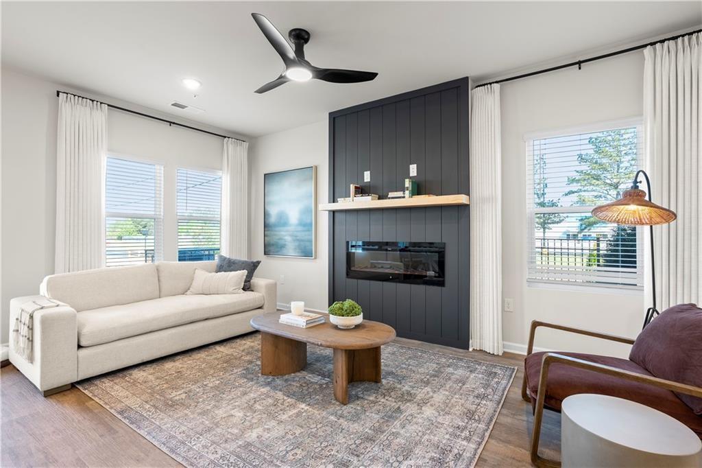 5299 Magnolia Grove Way, Unit 182 Gainesville, GA 30504 - Photo 30 of 79 a living room with furniture and a fireplace