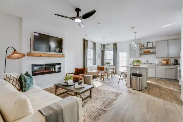 a view of kitchen with refrigerator and white cabinets