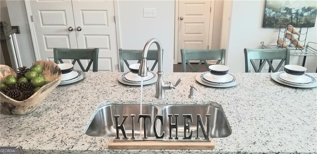 5299 Magnolia Grove Way, Unit 182 Gainesville, GA 30504 - Photo 35 of 79 a view of a dining room with furniture and a potted plant