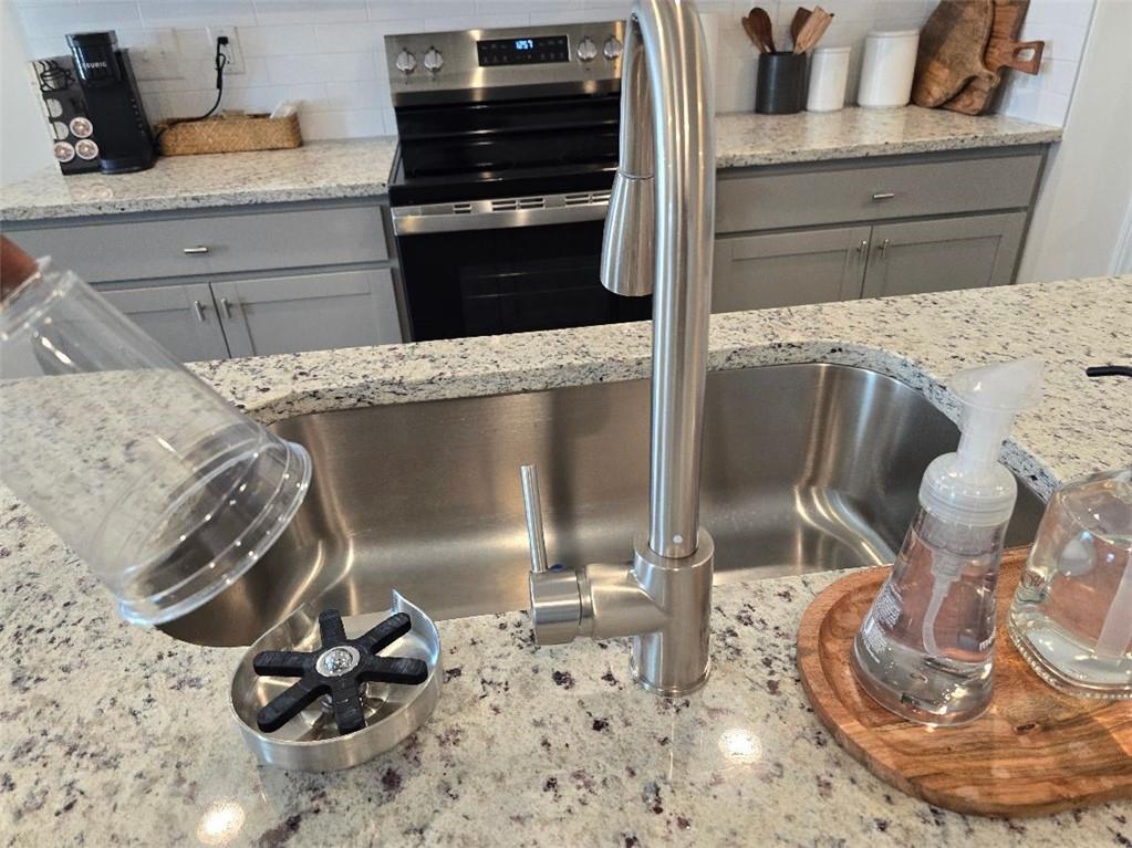 5299 Magnolia Grove Way, Unit 182 Gainesville, GA 30504 - Photo 39 of 79 a kitchen with a stove and a wooden floor