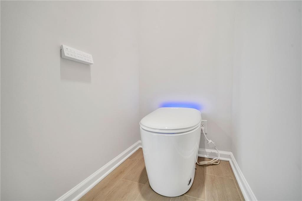 5299 Magnolia Grove Way, Unit 182 Gainesville, GA 30504 - Photo 63 of 79 a bathroom with a toilet and a rug