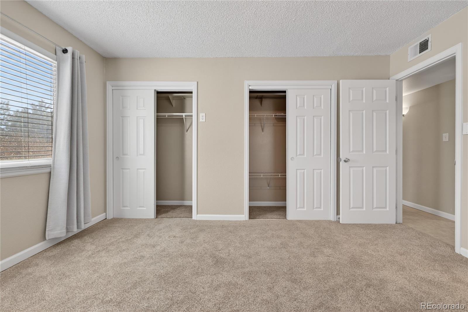 4400 South Quebec Street, Unit 101P Denver, CO 80237 - Photo 11 of 26 a view of an empty room with closet area