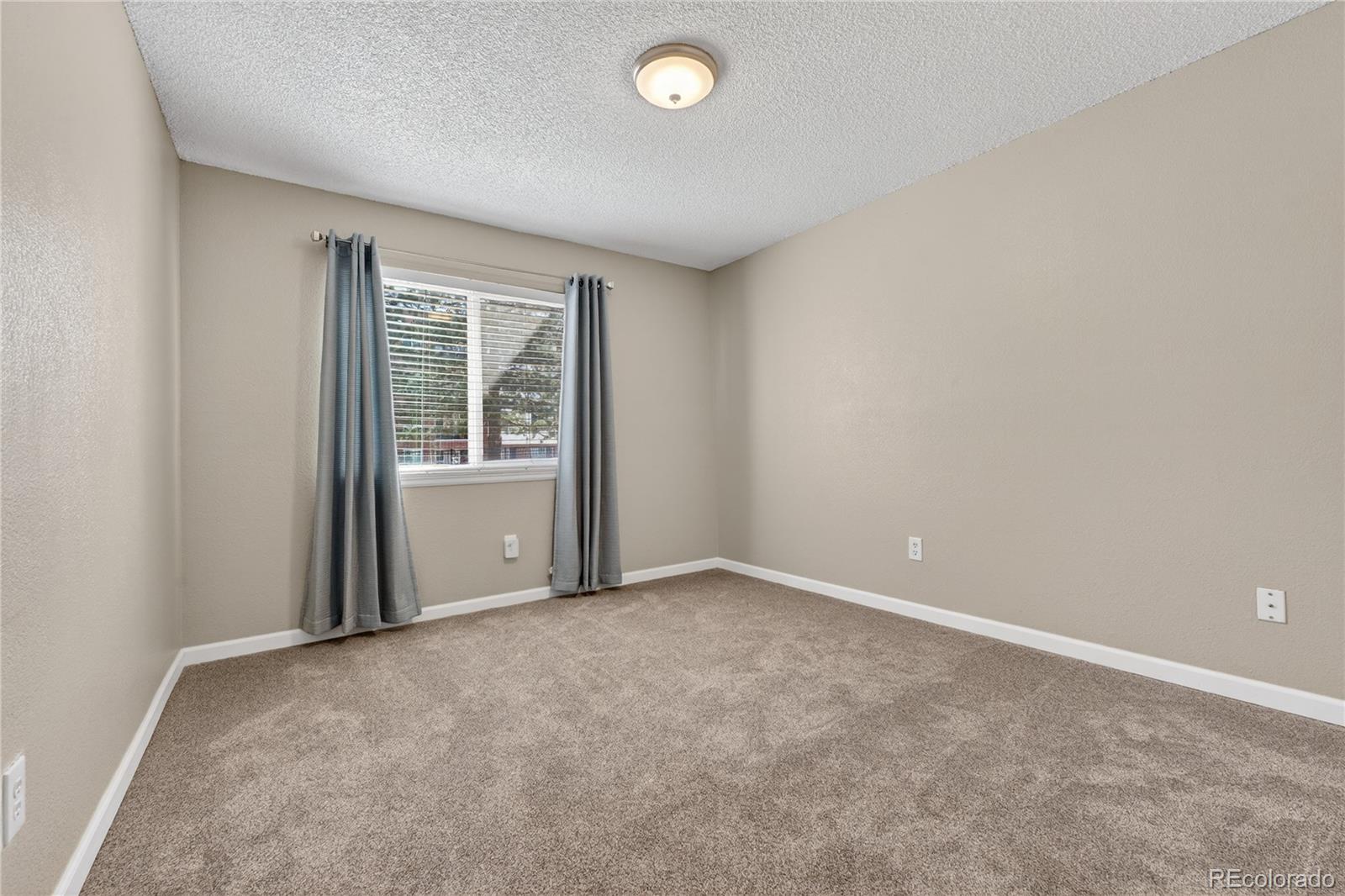 4400 South Quebec Street, Unit 101P Denver, CO 80237 - Photo 15 of 26 an empty room with windows and closet