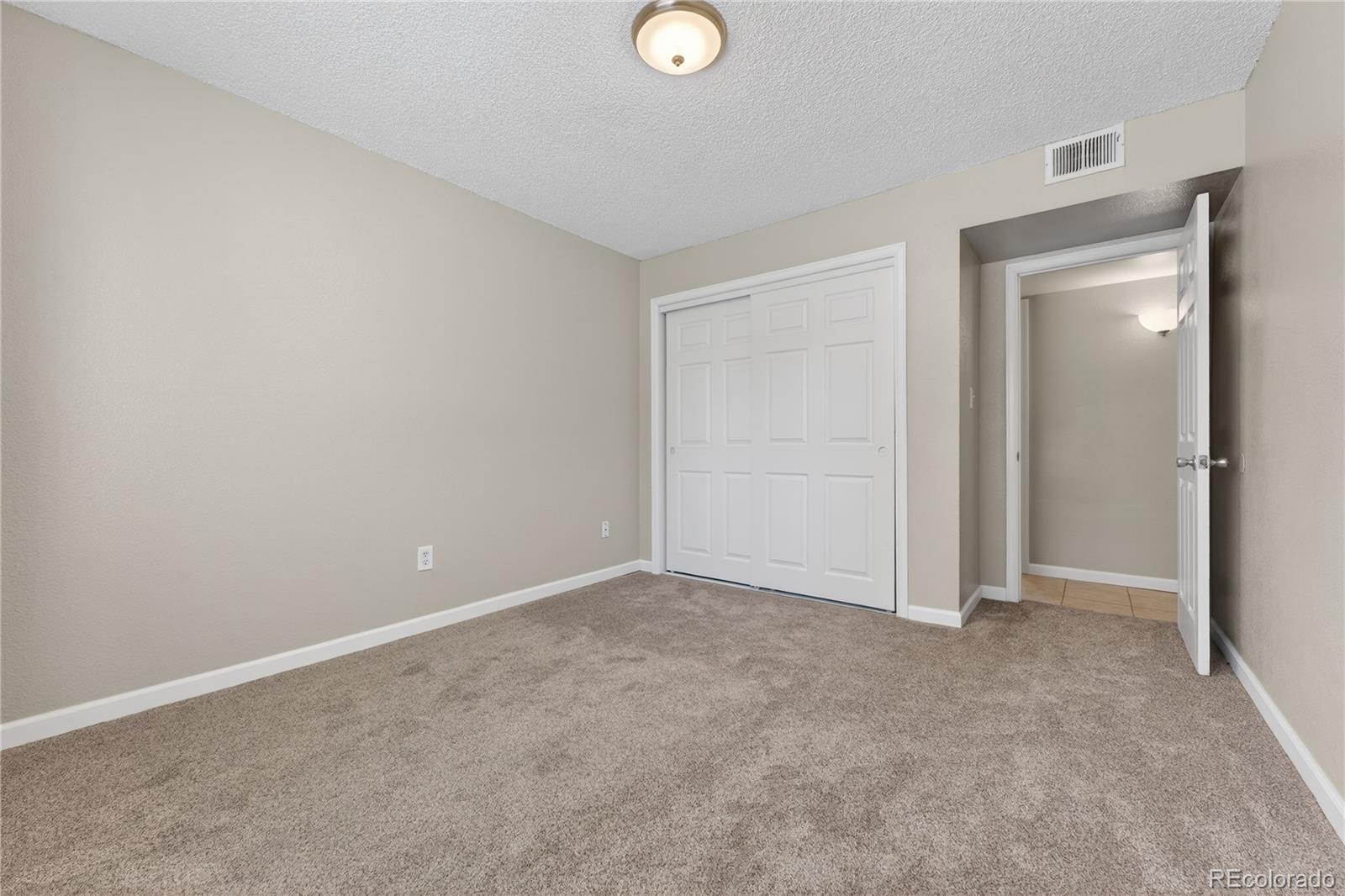 4400 South Quebec Street, Unit 101P Denver, CO 80237 - Photo 16 of 26 a view of an empty room and window