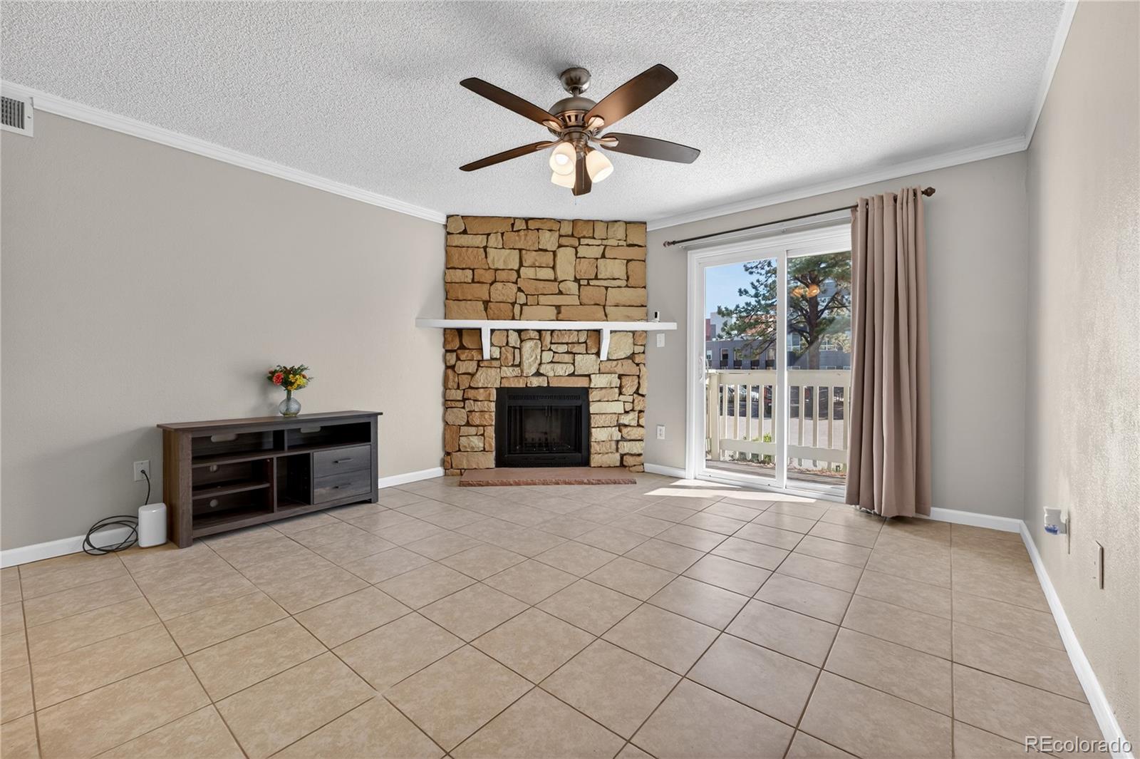 4400 South Quebec Street, Unit 101P Denver, CO 80237 - Photo 3 of 26 a living room with furniture and a fireplace