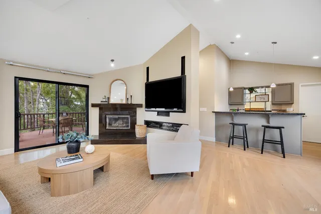 a living room with furniture a flat screen tv and a large window