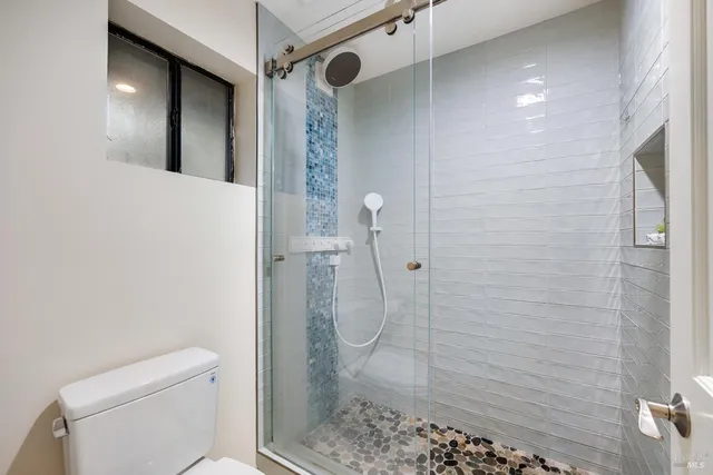 a bathroom with a shower and toilet