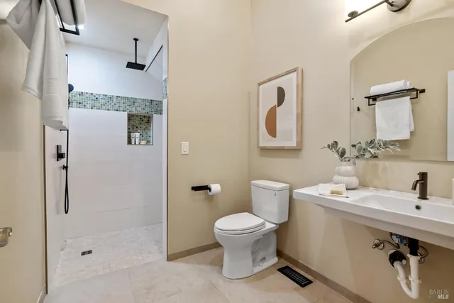 a bathroom with a sink toilet and shower