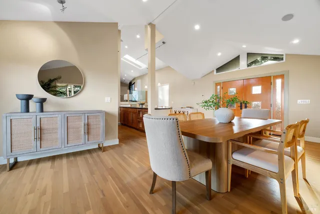 a dining room with furniture and wooden floor