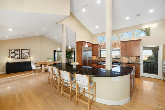 a large kitchen with a table and chairs