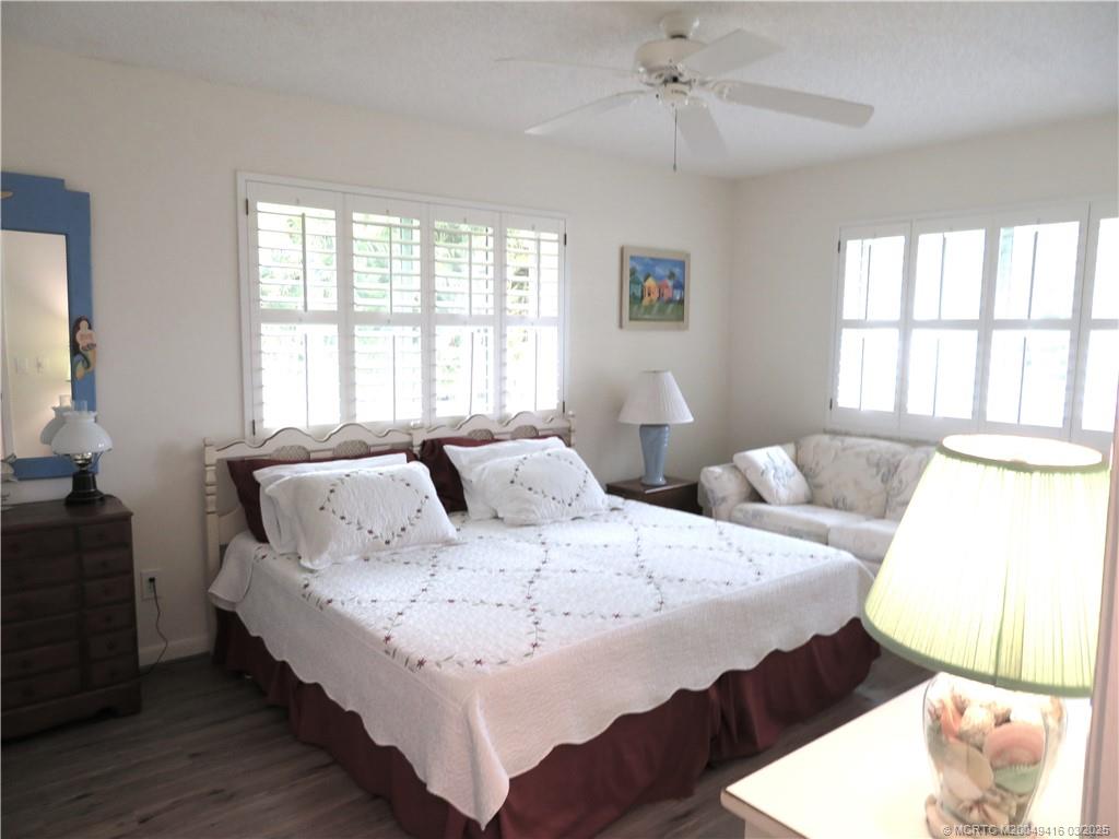 1843 Southeast Granada Lane Stuart, FL 34996 - Photo 19 of 31 a large bedroom with a bed and wooden floor