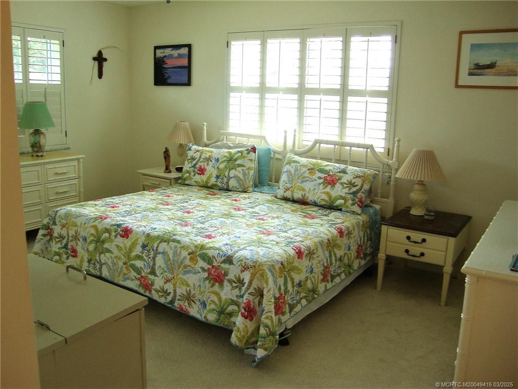 1843 Southeast Granada Lane Stuart, FL 34996 - Photo 20 of 31 a bedroom with a bed and window