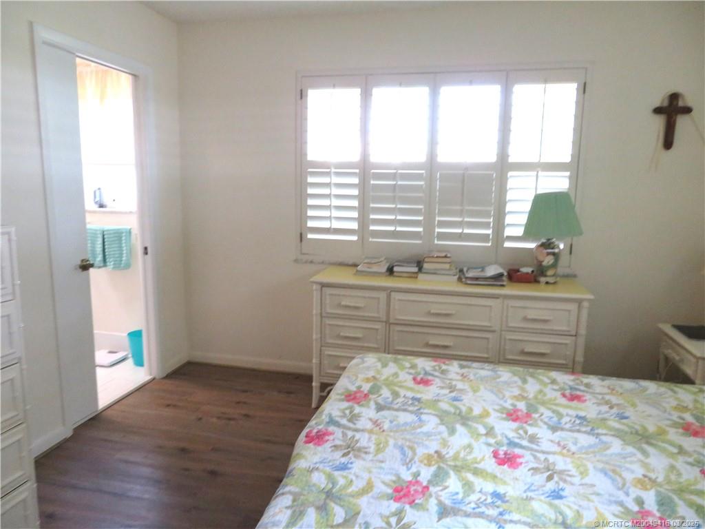 1843 Southeast Granada Lane Stuart, FL 34996 - Photo 21 of 31 a room with wooden floor and window