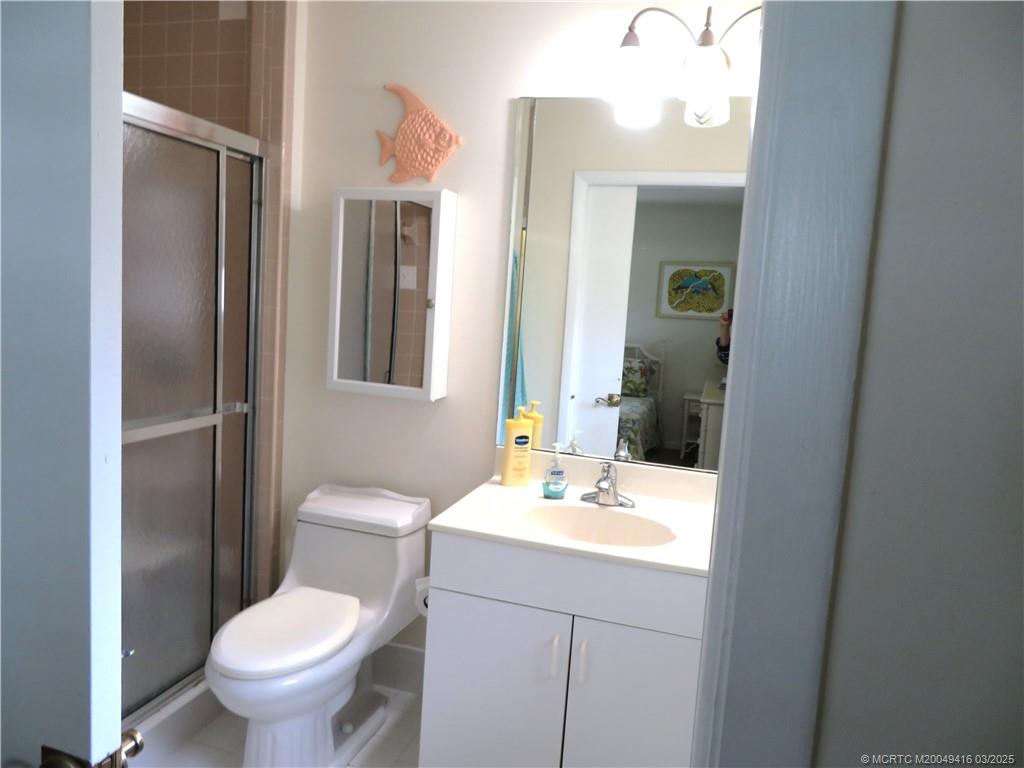 1843 Southeast Granada Lane Stuart, FL 34996 - Photo 22 of 31 a bathroom with a toilet sink and mirror