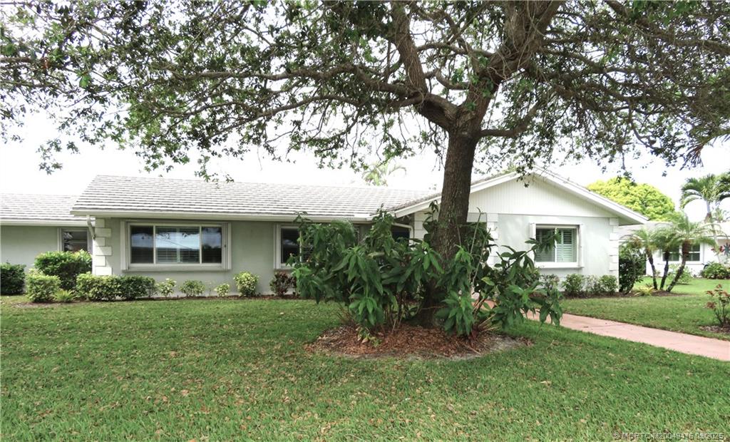 1843 Southeast Granada Lane Stuart, FL 34996 - Photo 4 of 31 a front view of house with a garden