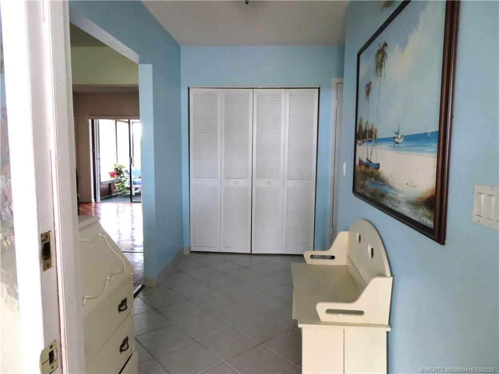 1843 Southeast Granada Lane Stuart, FL 34996 - Photo 8 of 31 a view of a hallway with wooden floor and a bathroom