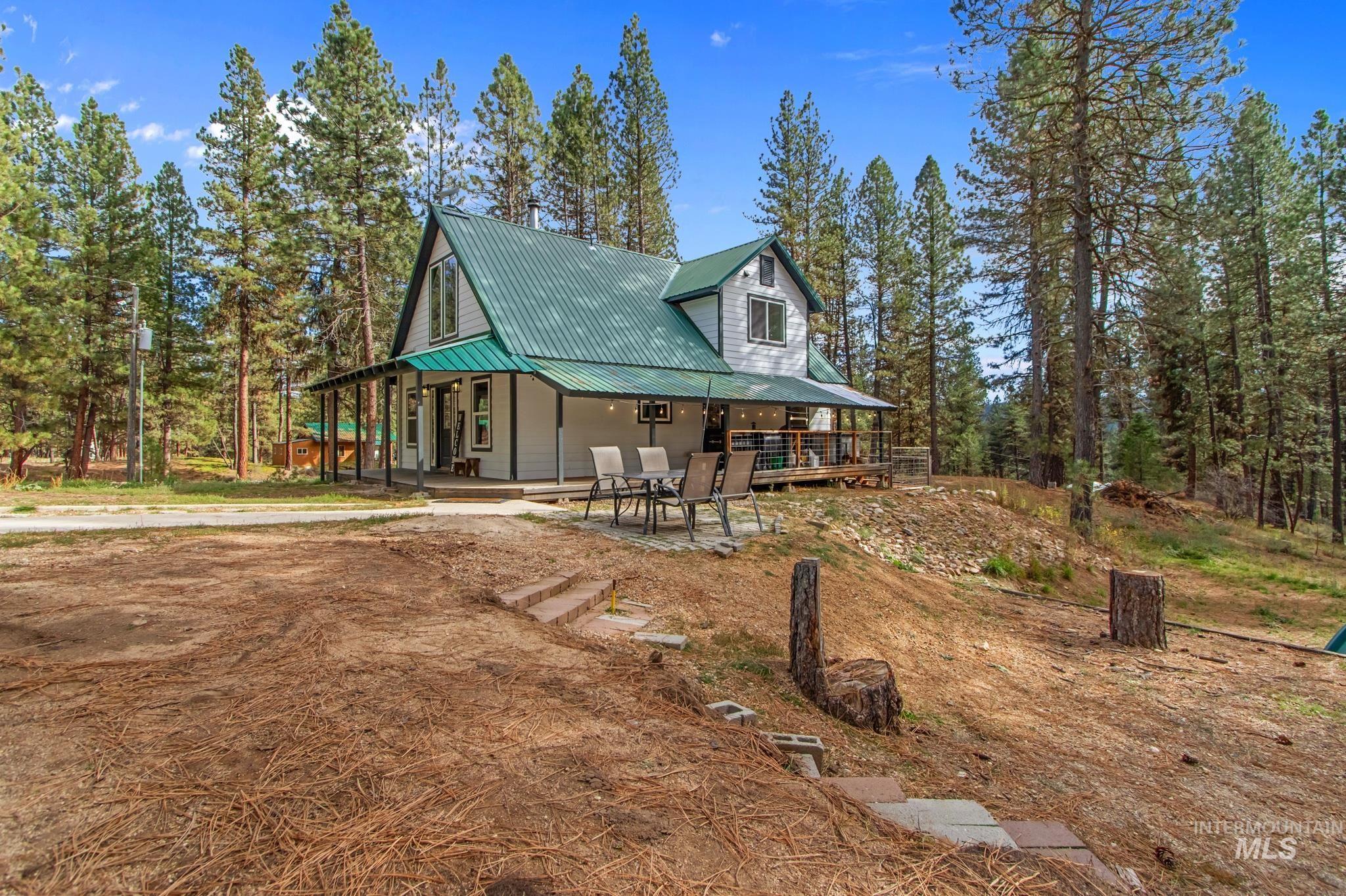 Rustic home with a porch and a metal roof