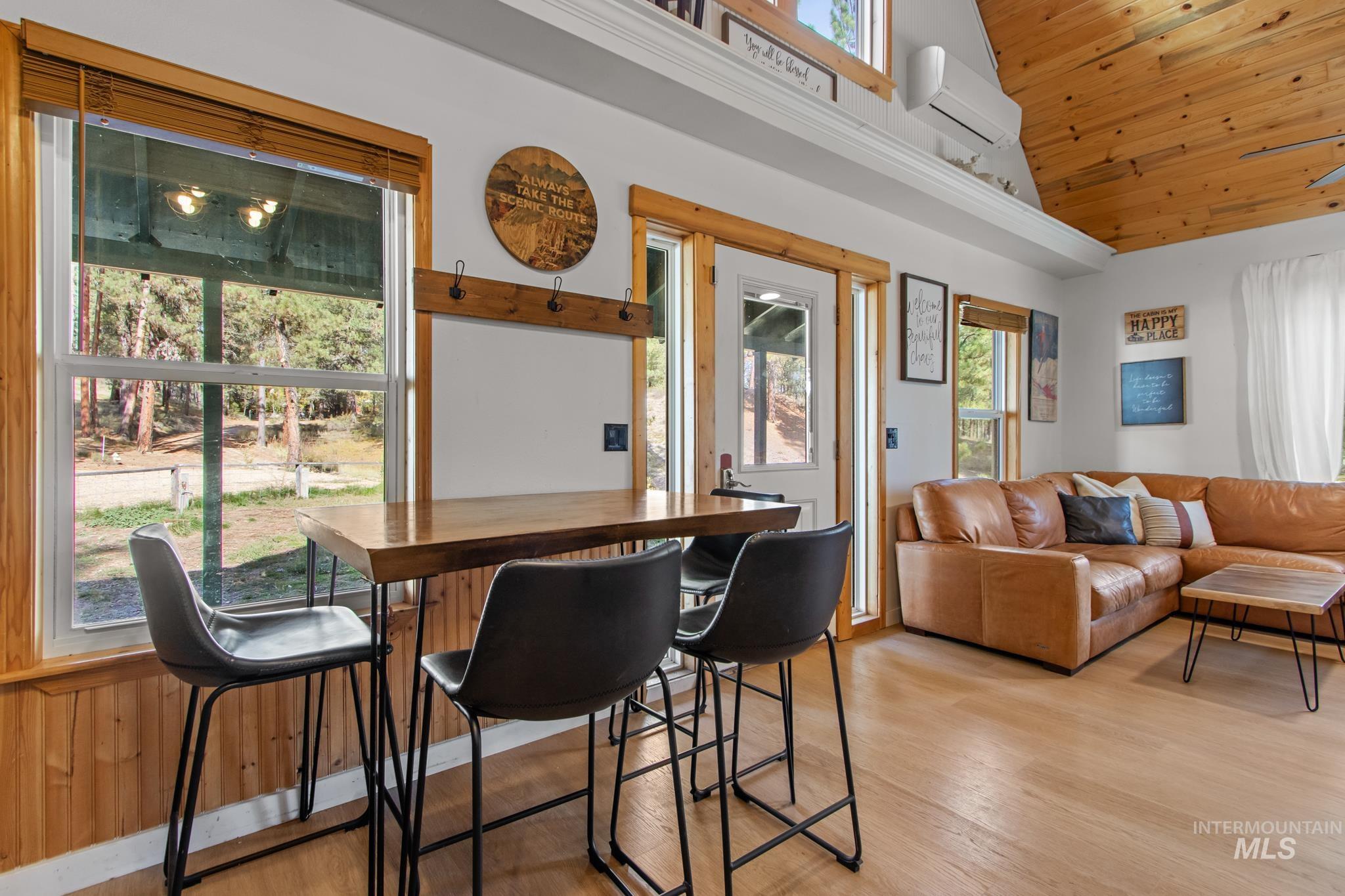12 Meadow Creek Road Idaho City, ID 83631 - Photo 13 of 44 Dining room with wooden ceiling, a wall unit AC, light wood-style flooring, and high vaulted ceiling