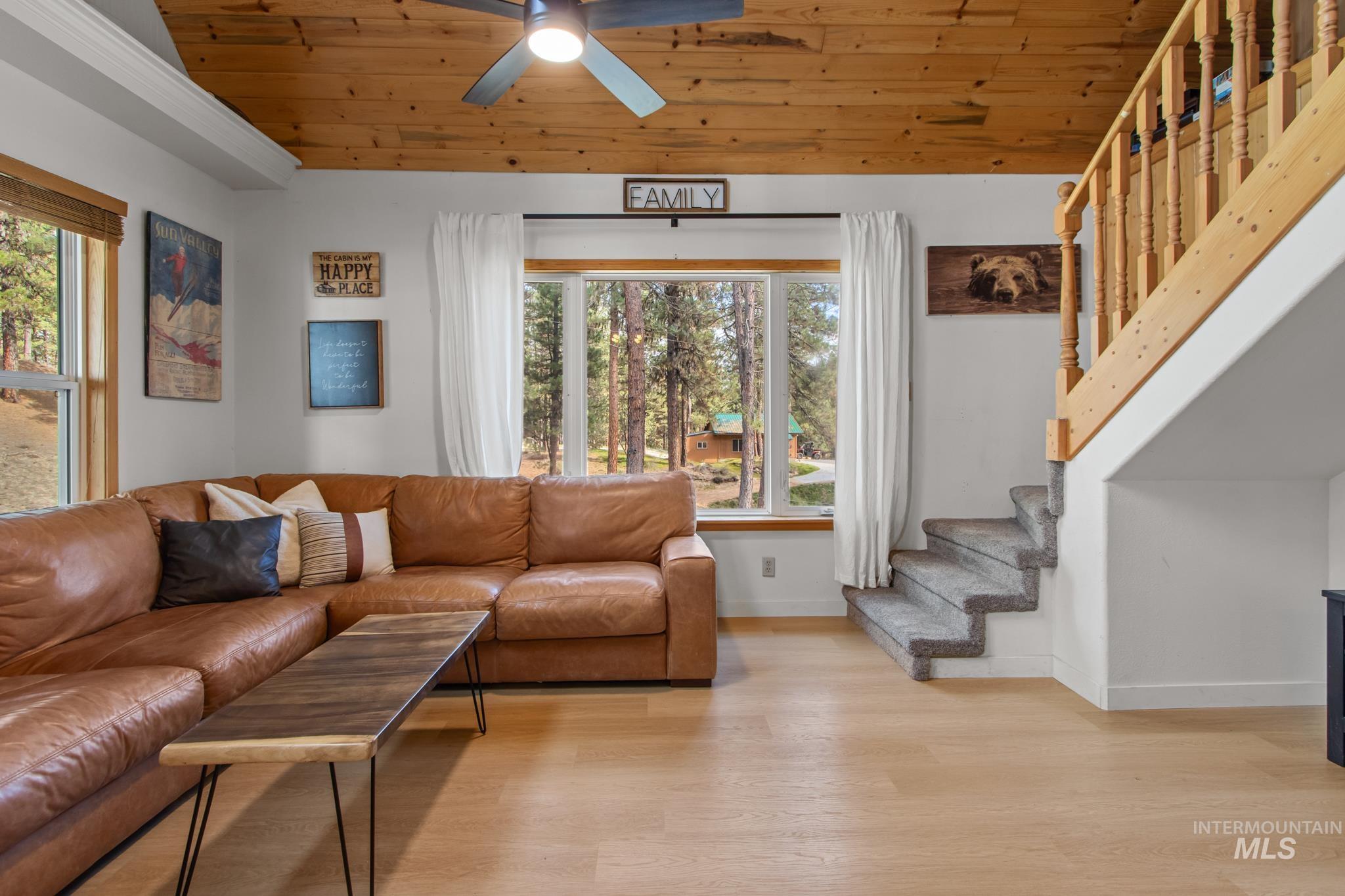 12 Meadow Creek Road Idaho City, ID 83631 - Photo 16 of 44 Living area featuring wooden ceiling, light wood-type flooring, stairway, and ceiling fan