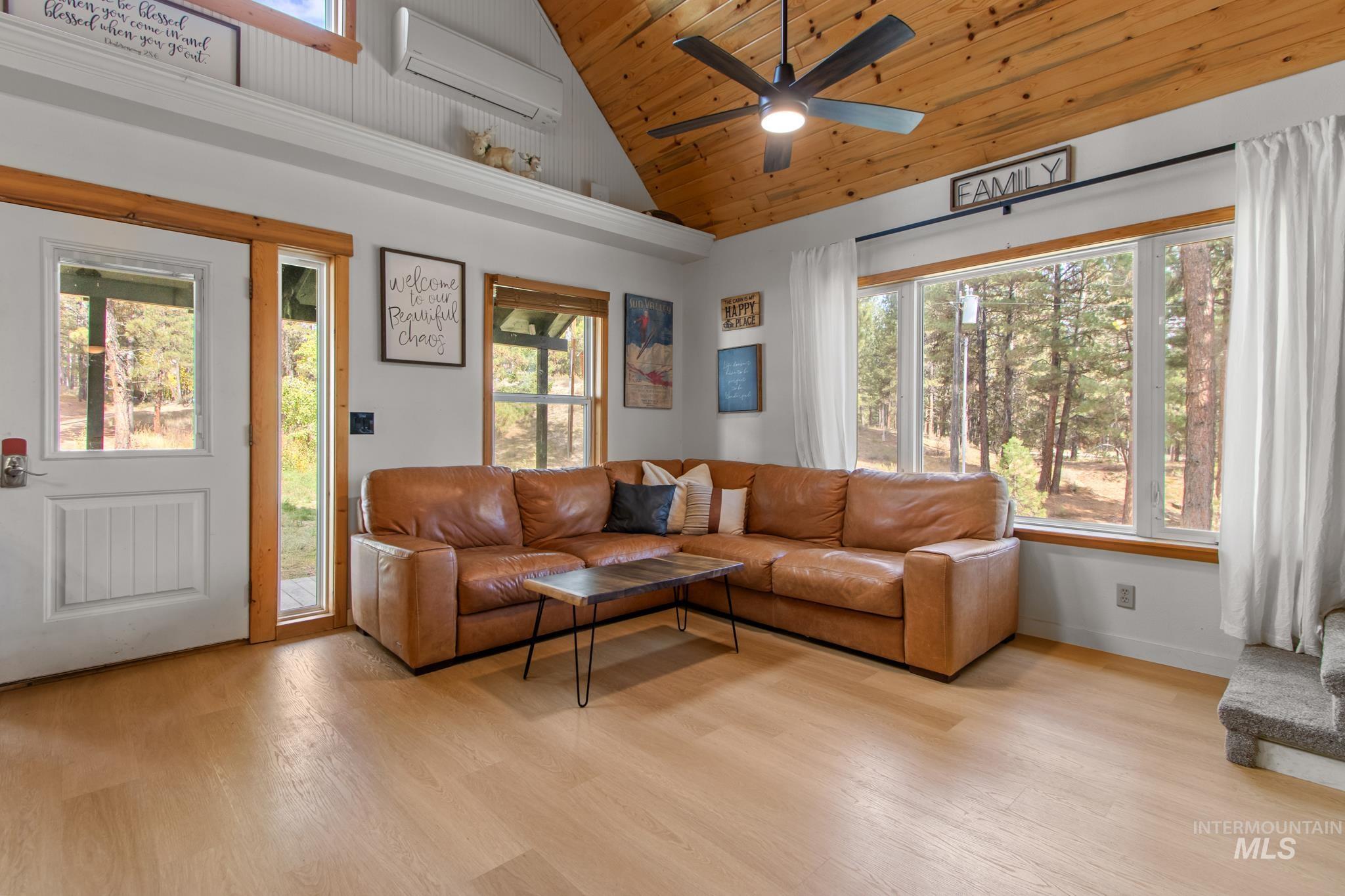 12 Meadow Creek Road Idaho City, ID 83631 - Photo 17 of 44 Living room with light wood-style floors, a wall mounted air conditioner, wood ceiling, high vaulted ceiling, and a ceiling fan