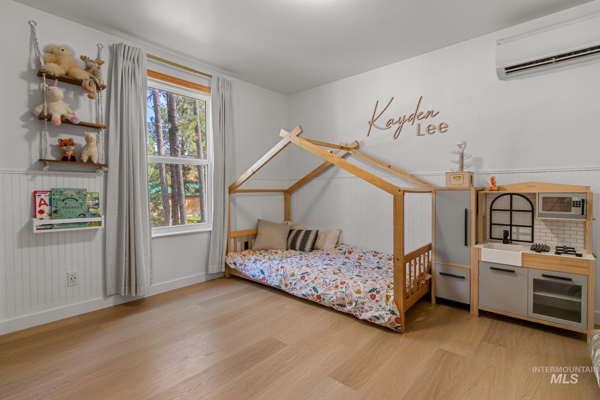 12 Meadow Creek Road Idaho City, ID 83631 - Photo 19 of 44 Bedroom with light wood-style flooring and a wall mounted AC