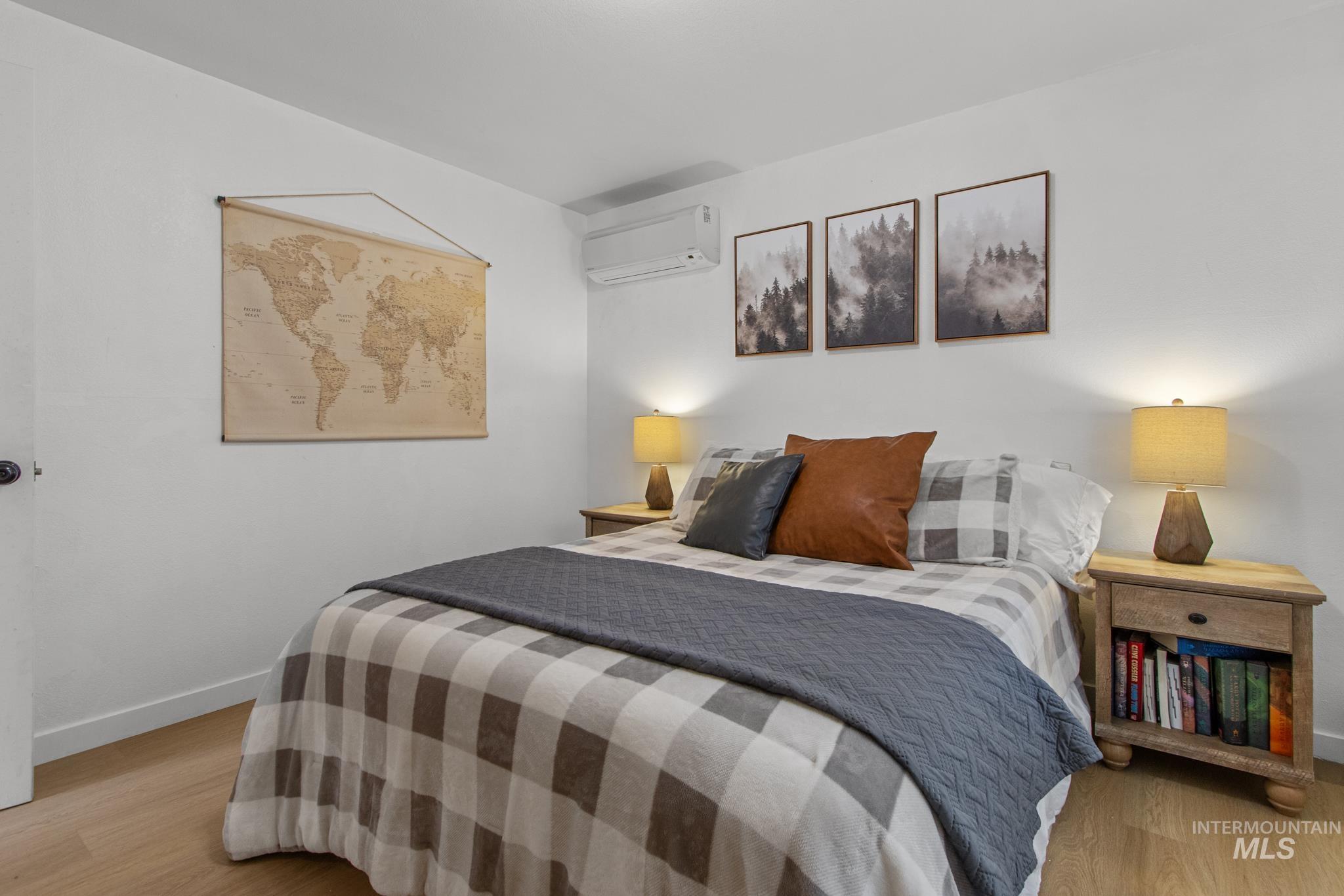 12 Meadow Creek Road Idaho City, ID 83631 - Photo 21 of 44 Bedroom with light wood finished floors and a wall unit AC