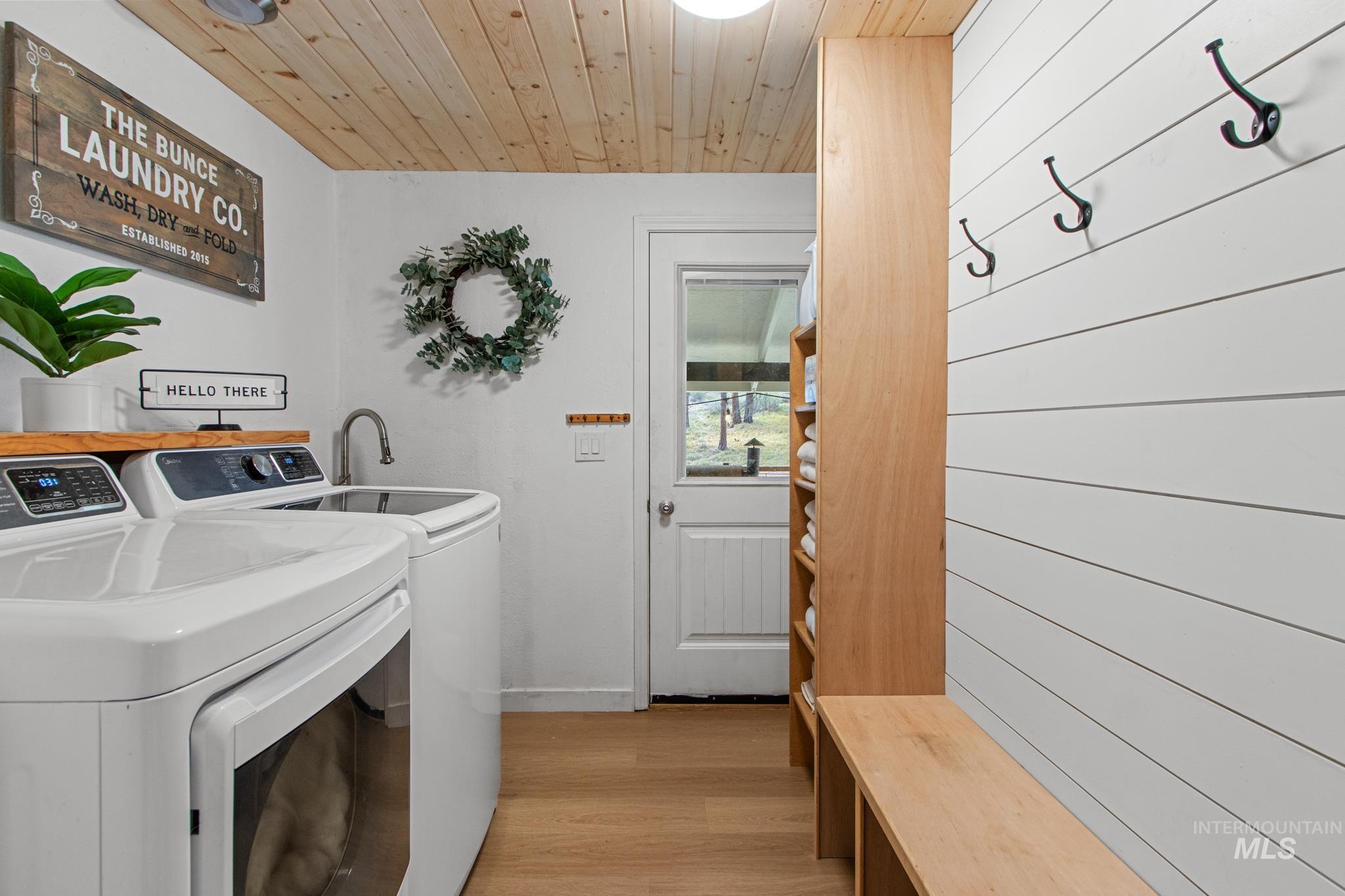 12 Meadow Creek Road Idaho City, ID 83631 - Photo 24 of 44 Washroom with light wood finished floors, washing machine and dryer, and wooden ceiling