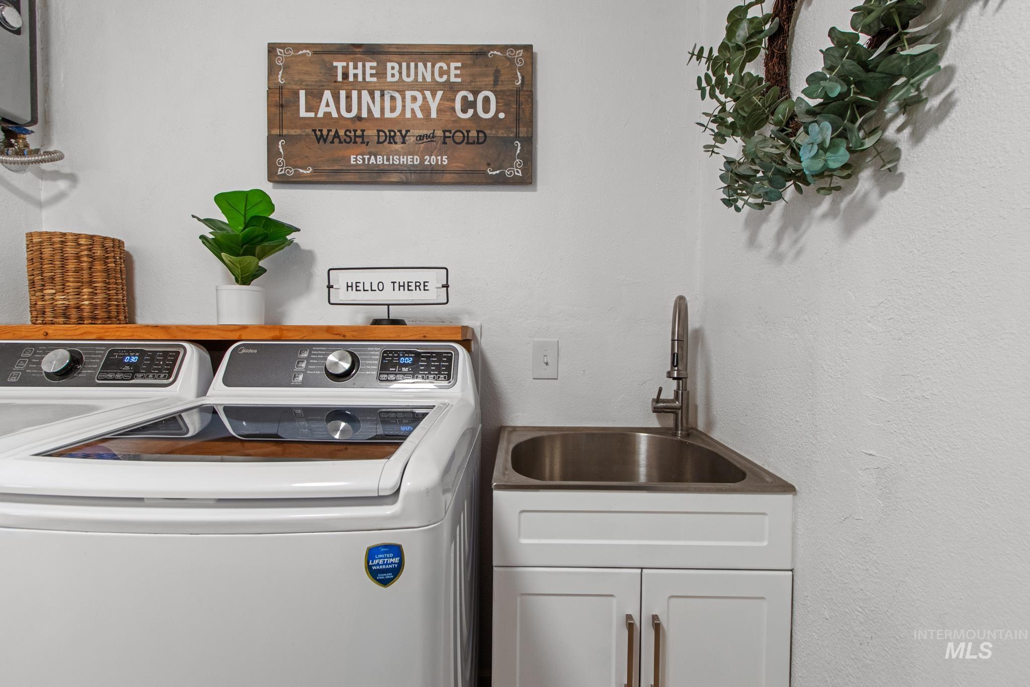 12 Meadow Creek Road Idaho City, ID 83631 - Photo 25 of 44 Laundry room with washing machine and dryer and a textured wall