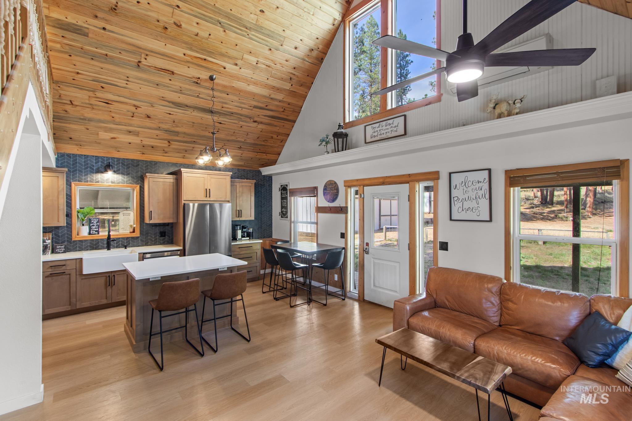 12 Meadow Creek Road Idaho City, ID 83631 - Photo 26 of 44 Living area featuring plenty of natural light, high vaulted ceiling, wood ceiling, light wood-type flooring, and a ceiling fan