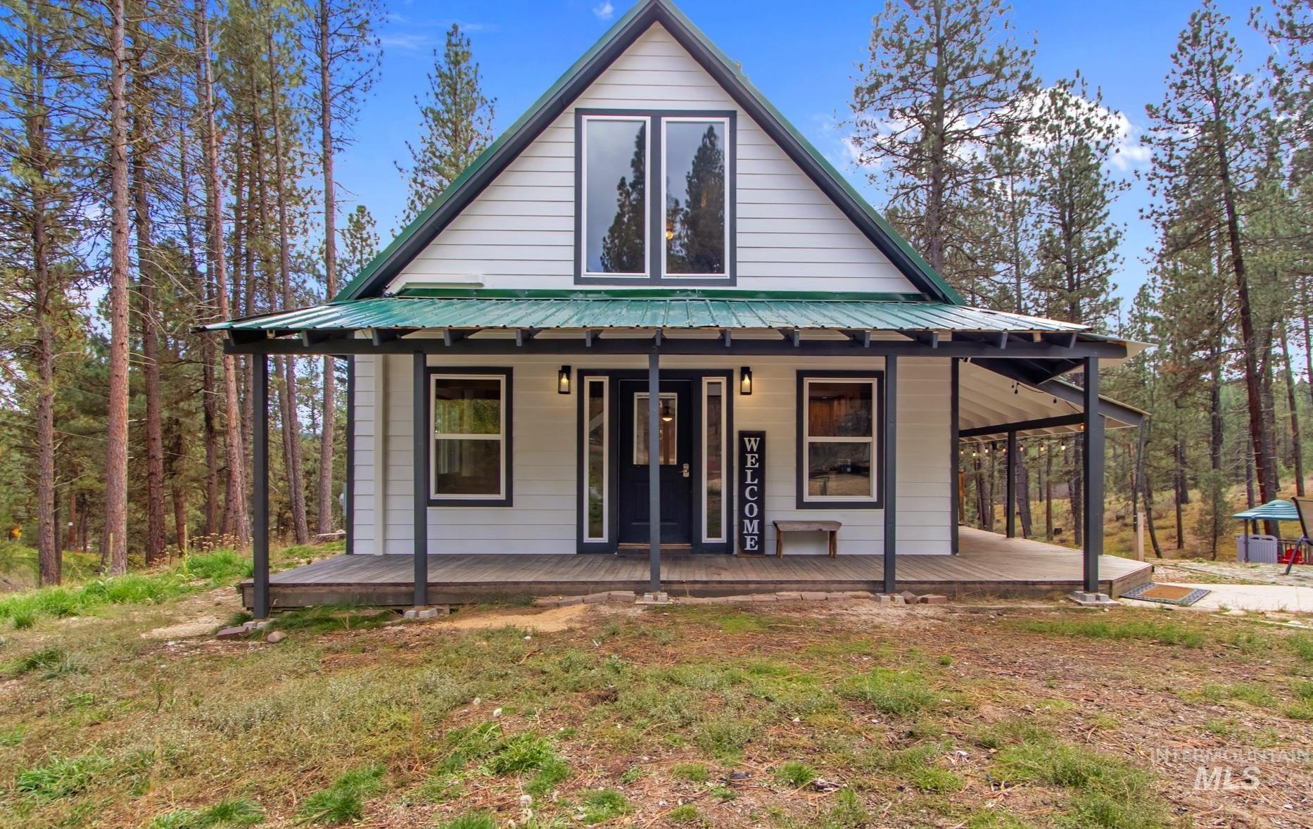 12 Meadow Creek Road Idaho City, ID 83631 - Photo 3 of 44 View of front of house featuring covered porch and a metal roof