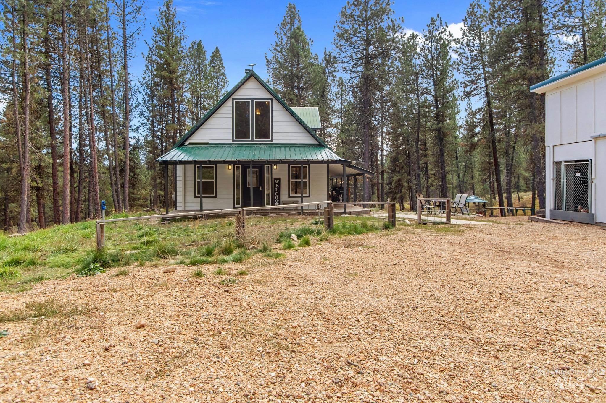 12 Meadow Creek Road Idaho City, ID 83631 - Photo 36 of 44 Rear view of property featuring covered porch and a metal roof